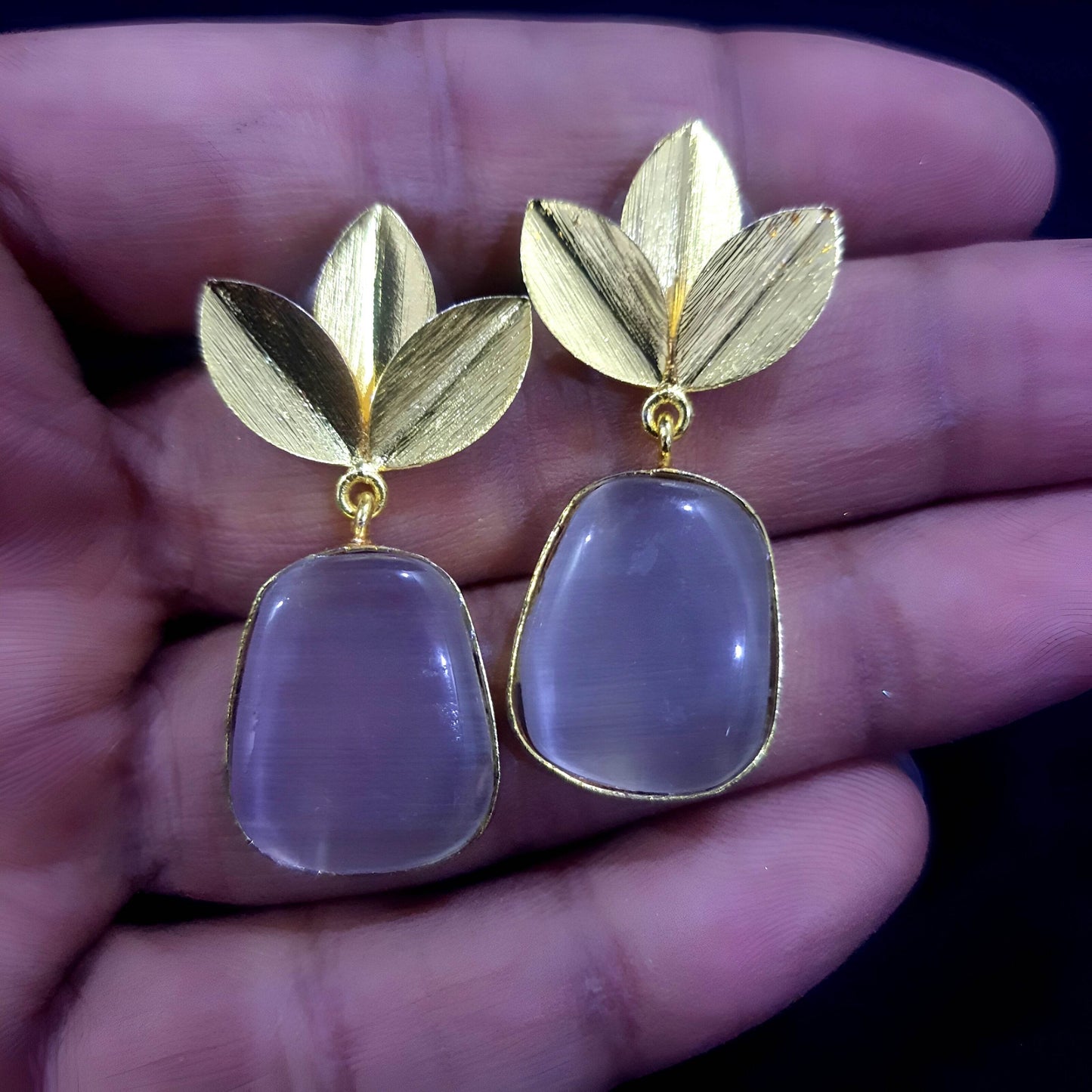 Amber stone leaf design earrings featuring a gold leaf accent and elegant drop shape