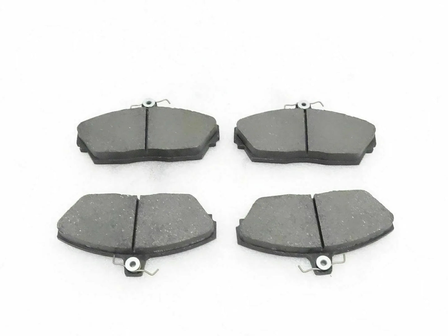 Disc brake pad set with four grey pads