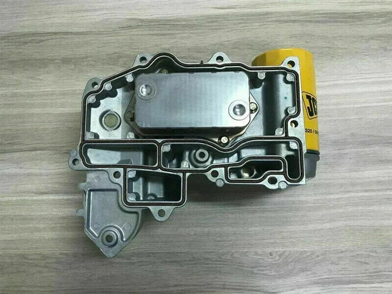 Oil cooler assembly with metal housing and mounting bolt holes