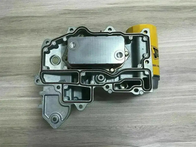 Oil cooler assembly with metal housing and mounting bolt holes