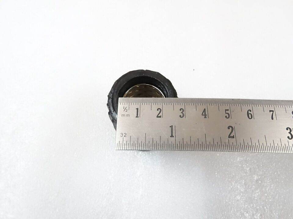 Ford tractor steering column bushing showing inner diameter with measuring ruler for precision fitting