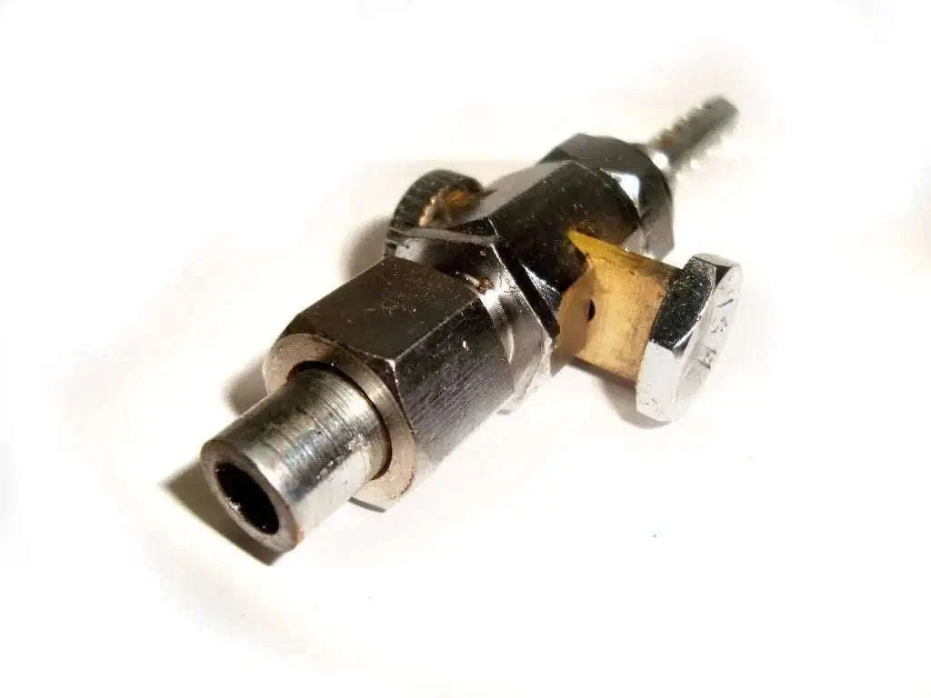Fuel petcock valve with black metal body and brass inlet, threaded outlet