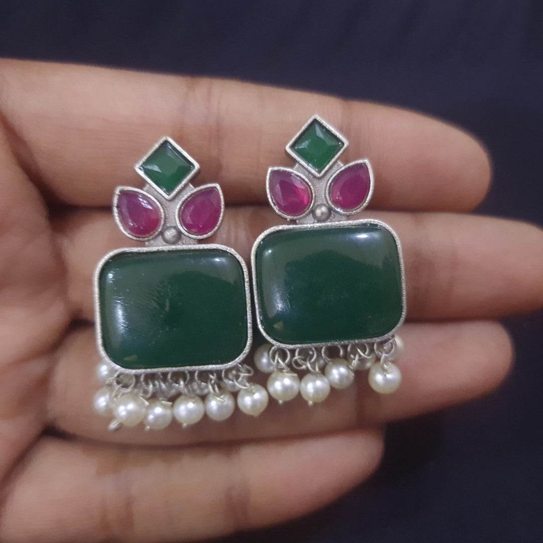 Elegant handcrafted brass drop earrings featuring green stone and pearl accents