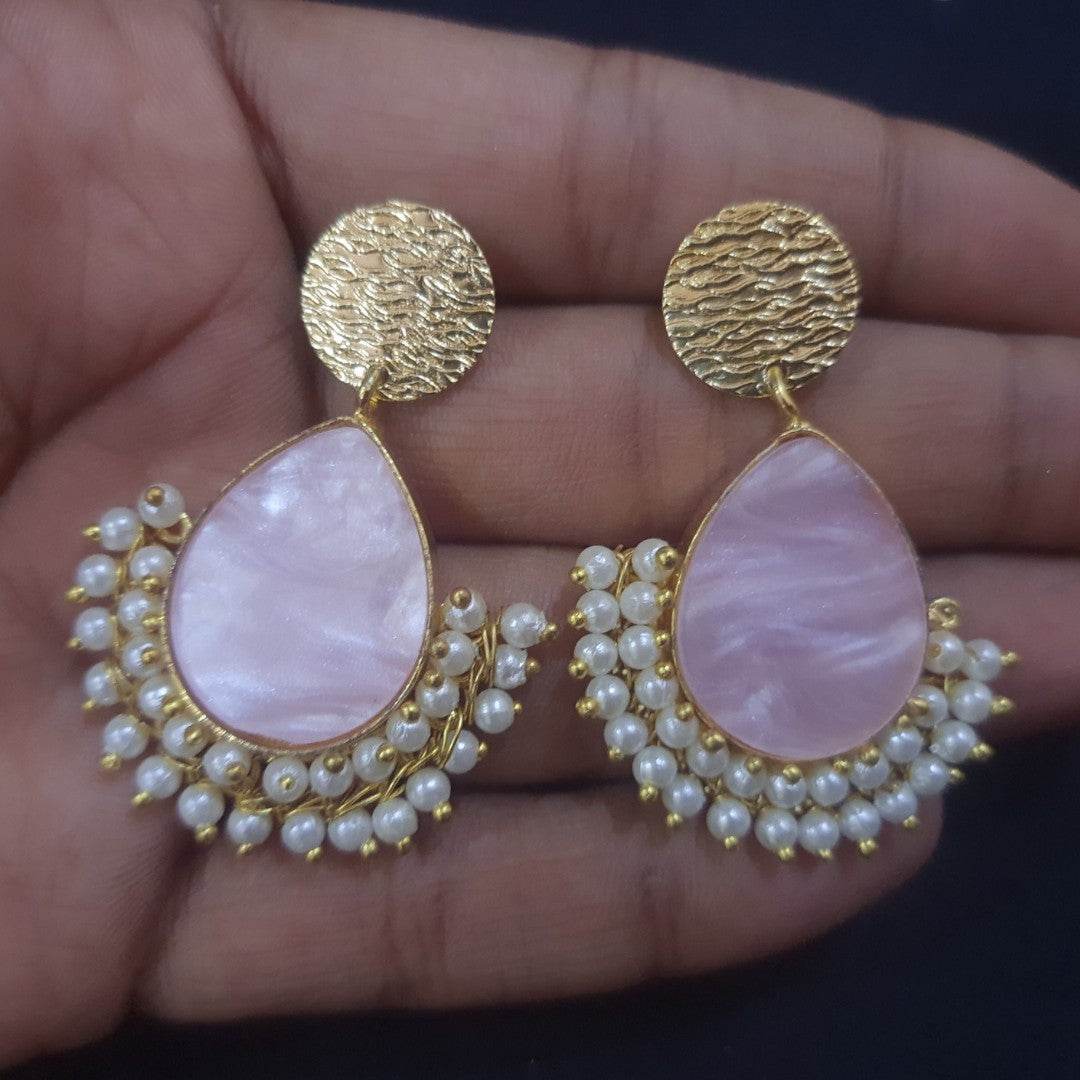 Stunning handcrafted brass pearl earrings featuring a teardrop design with delicate pearls
