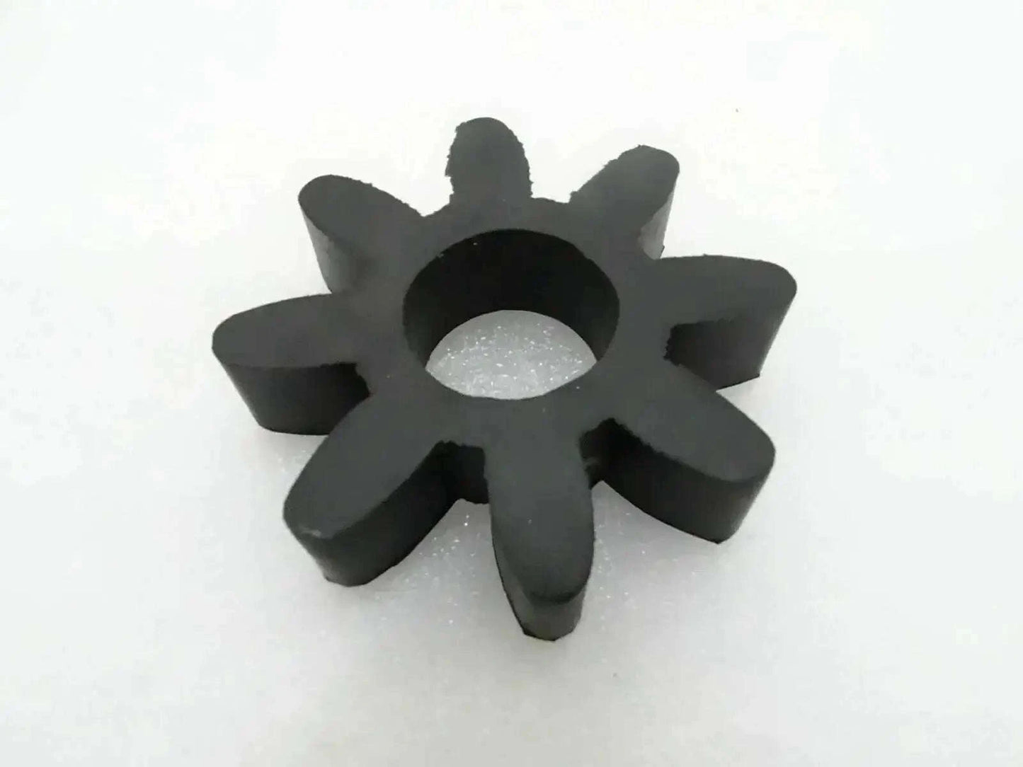 Black rubber coupling disk with star shape and central mounting hole