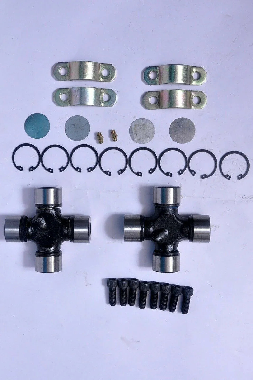 Universal joint kit with two cross assemblies, metal yokes, circlips, bolts and washers