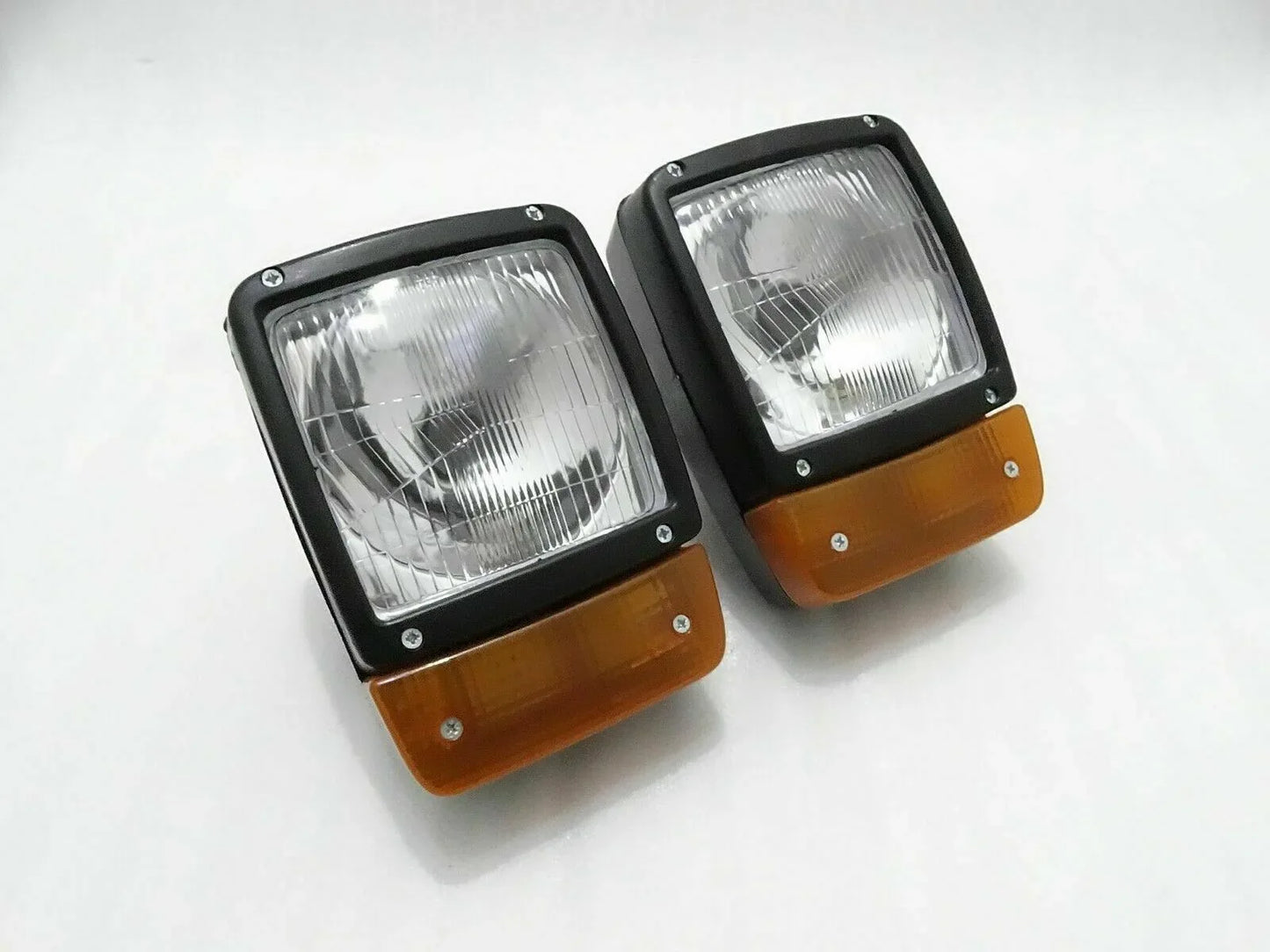 Pair of front headlights with amber indicator lenses, rectangular H4 lamps