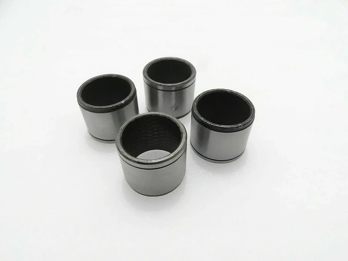 Set of 4 metal link bushings, cylindrical sleeves with open ends