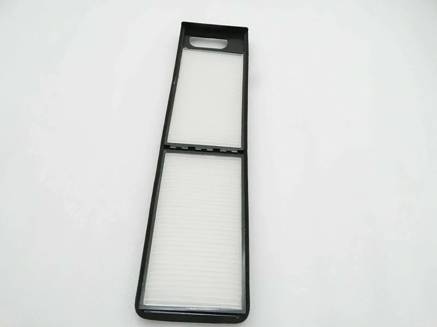 Cab air filter with two rectangular white filter elements in black frame