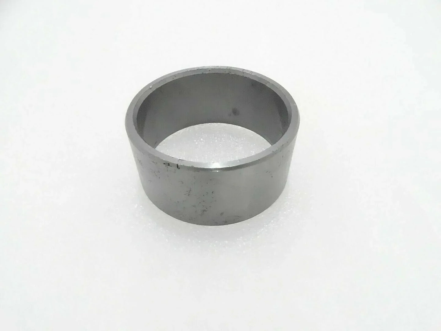 Gray metal inner bushing, cylindrical, open end.