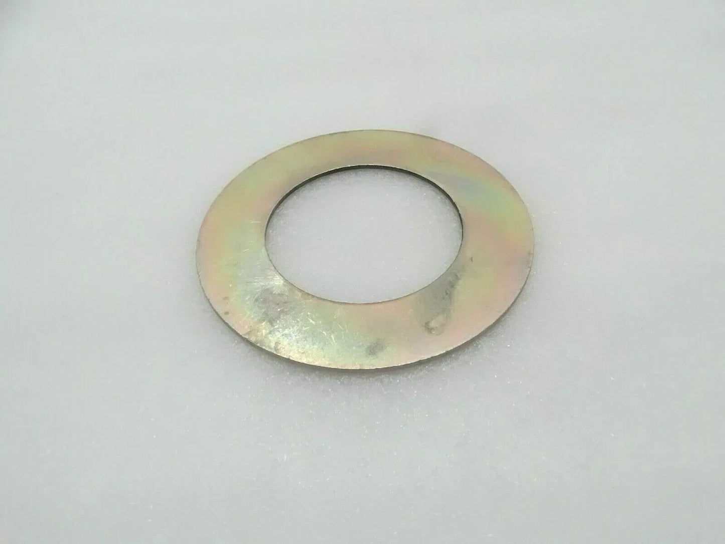 Metal circular shim washer with central hole, yellow-gold finish.