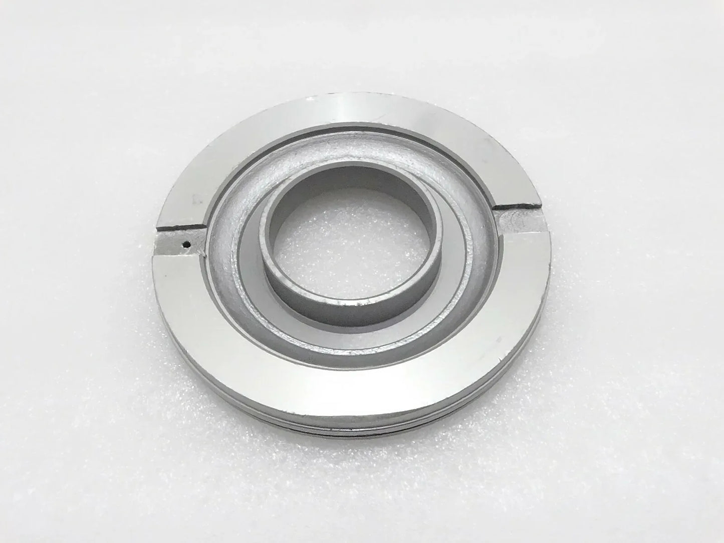 Metal piston assembly part with circular inner bore and outer ring, silver-gray