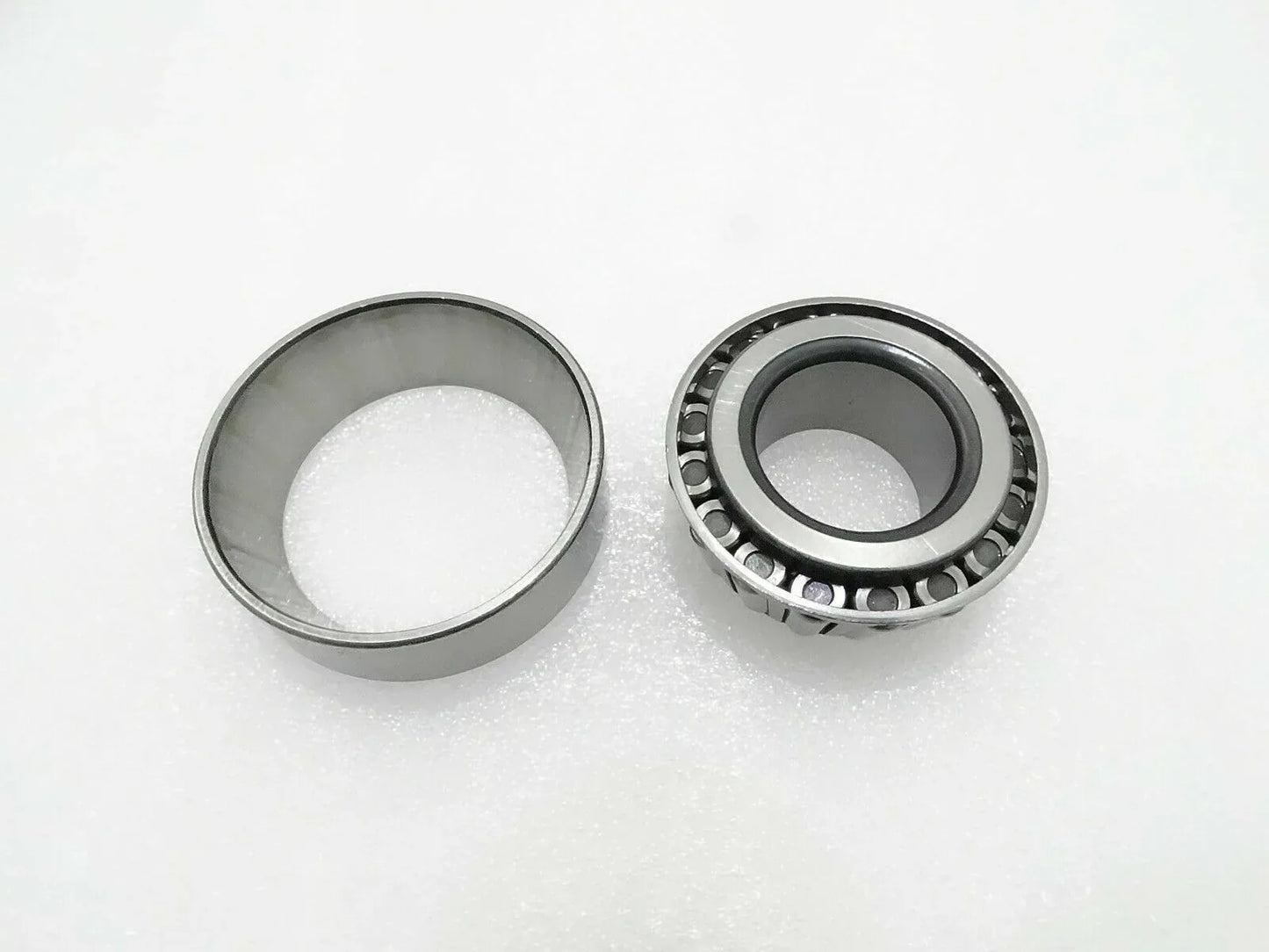 Thrust bearing with metal cage and roller assembly, shown with two rings
