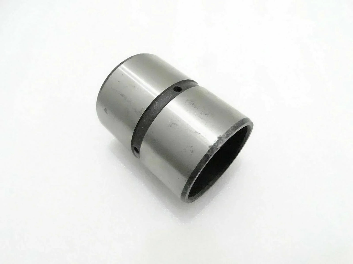 Cylindrical metal bushing with dark rubber ring