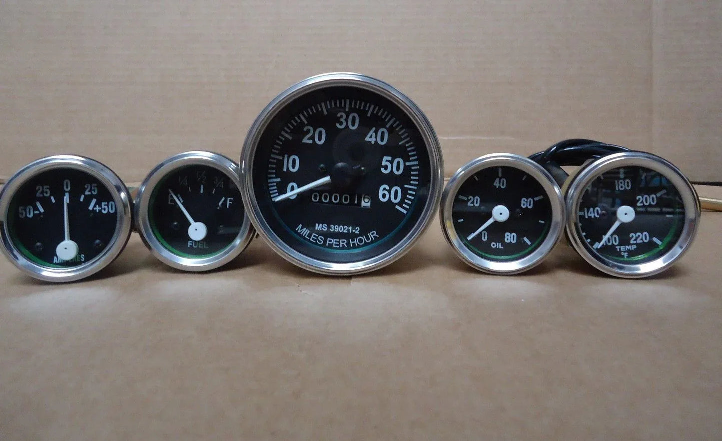 Speedometer gauge kit with five round gauges, chrome bezels, black faces