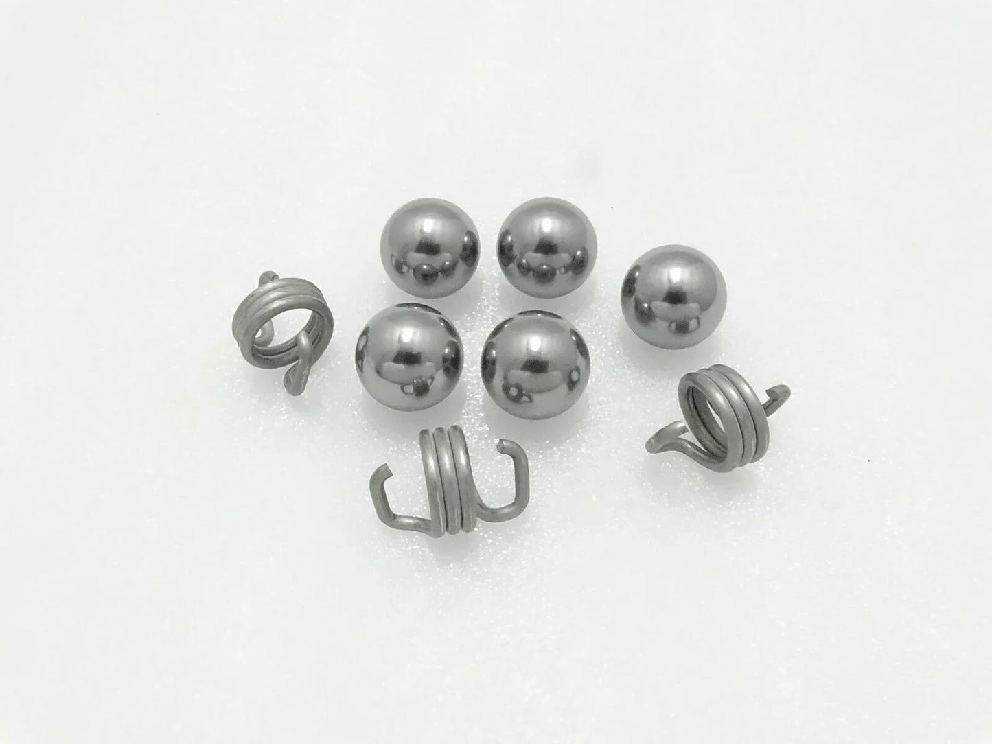 Tractor brake ball and spring kit with metal balls and coil springs