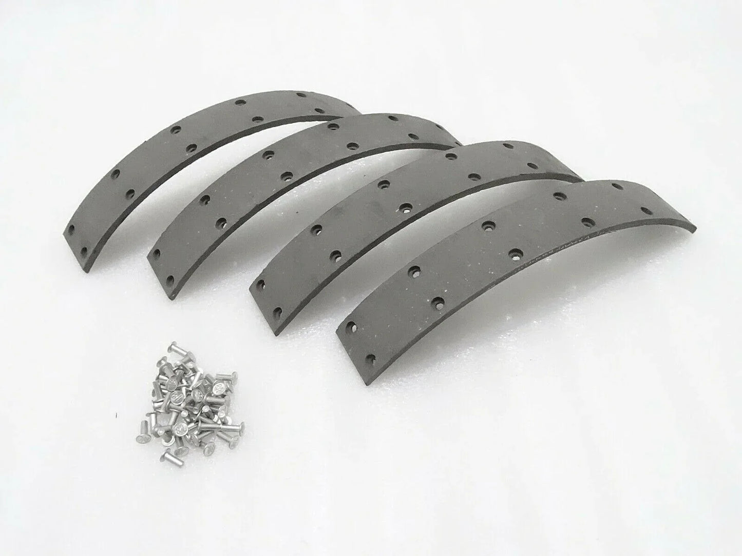 Rubber brake set for Massey Ferguson model with four curved pieces and mounting screws included