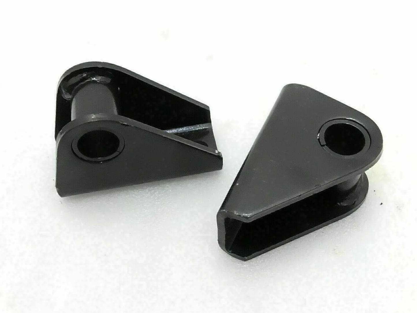 Suspension shackle bracket kit with two black metal brackets and mounting holes