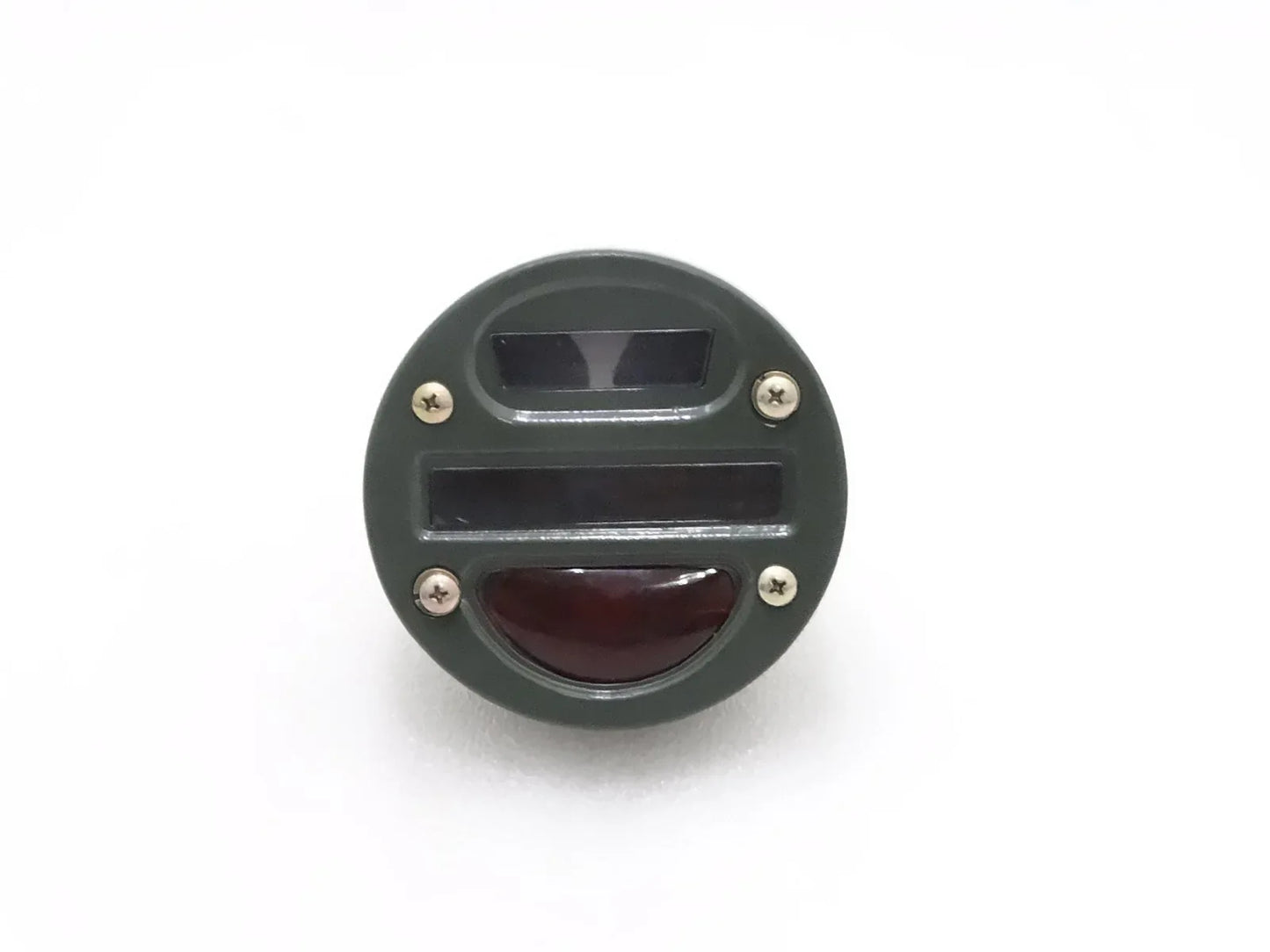 Round tail light cat-eye with clear top lens and red lower lens, black housing.