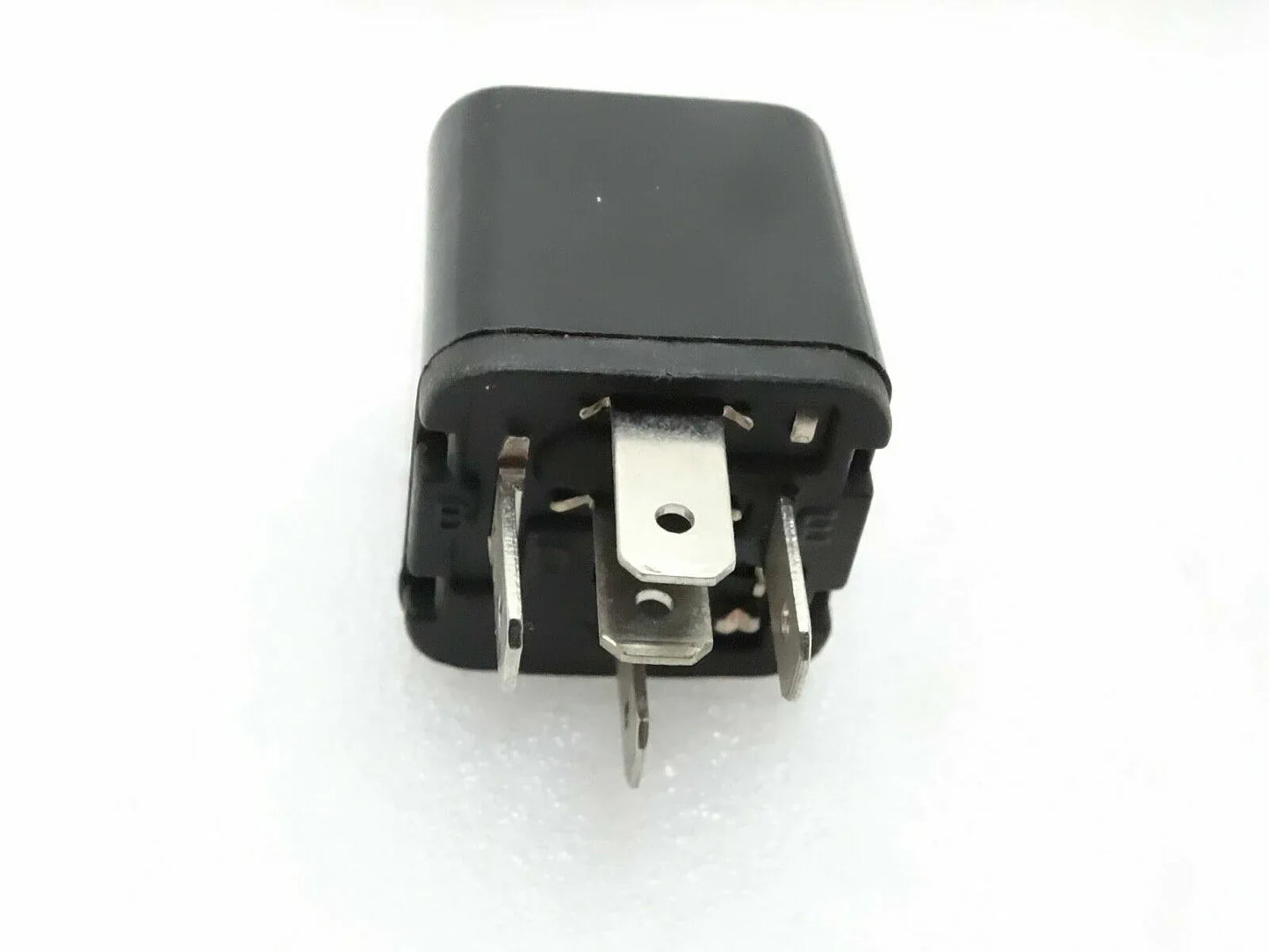 Black automotive relay switch with visible metal terminals
