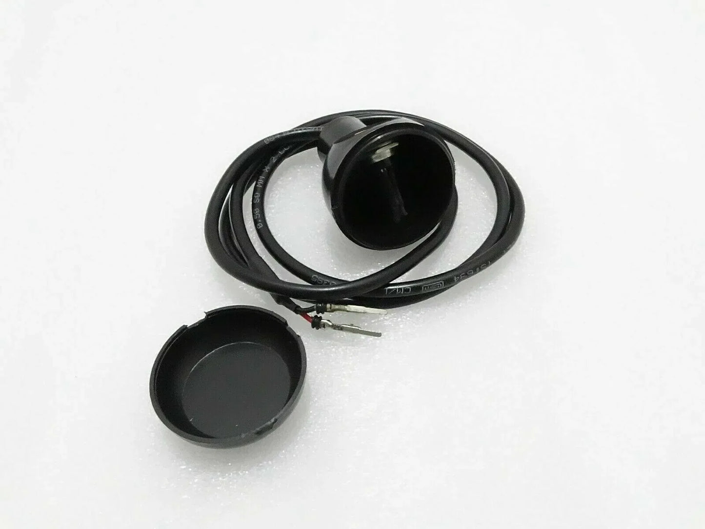 Micro switch with black round actuator cap and attached wire harness