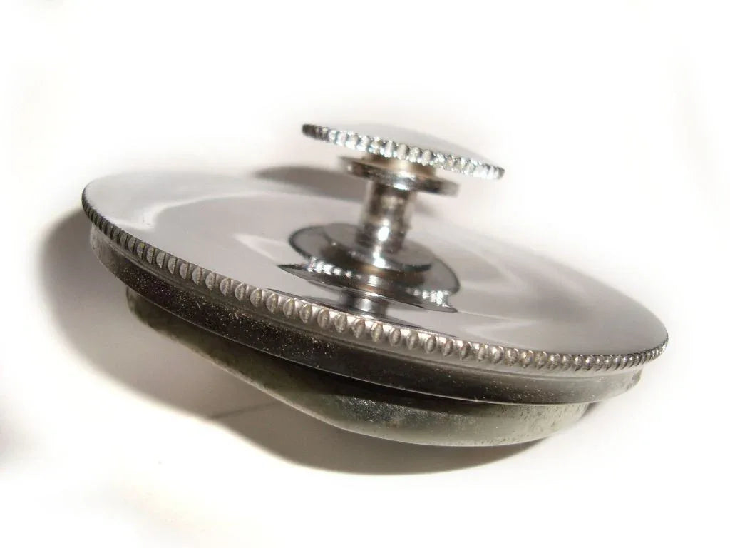 Stainless steel petrol tank cap with a smooth finish, designed for secure sealing