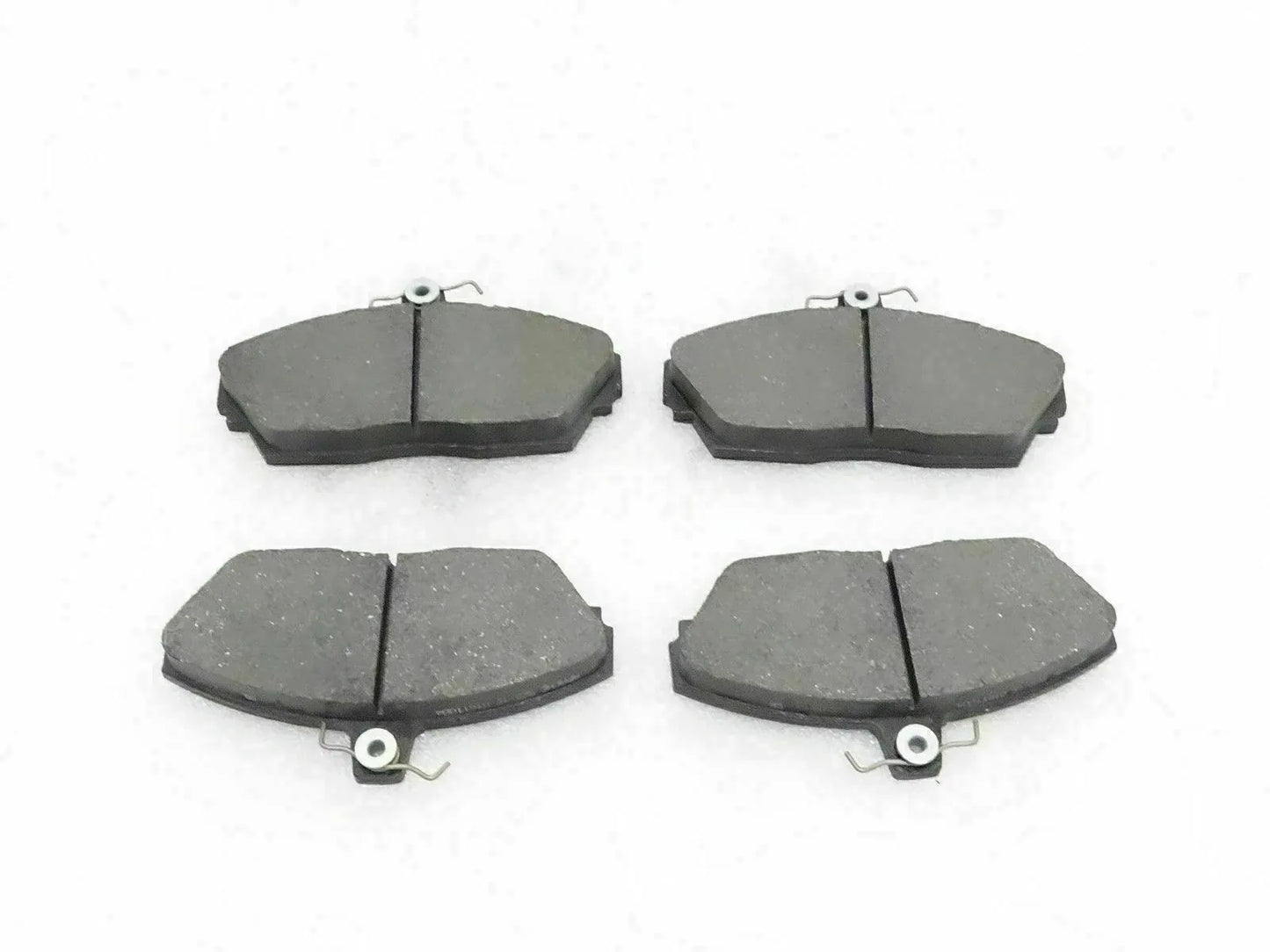 Disc brake pad set with four dark gray brake pads