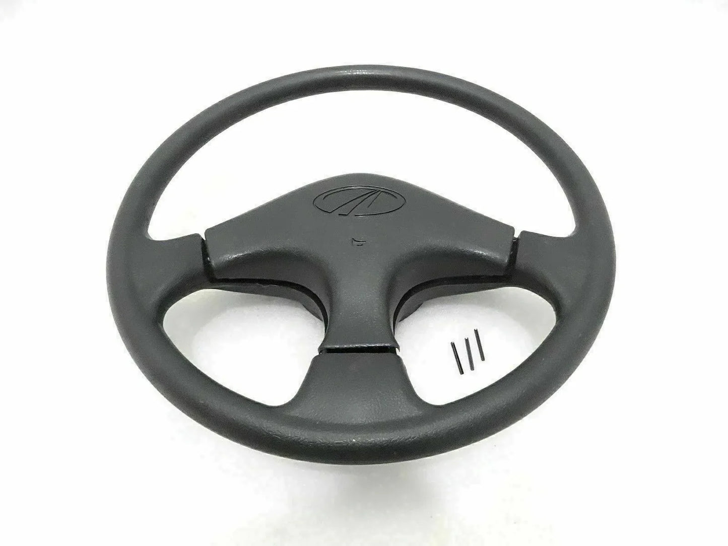 Black steering wheel with horn button center and three-spoke spokes