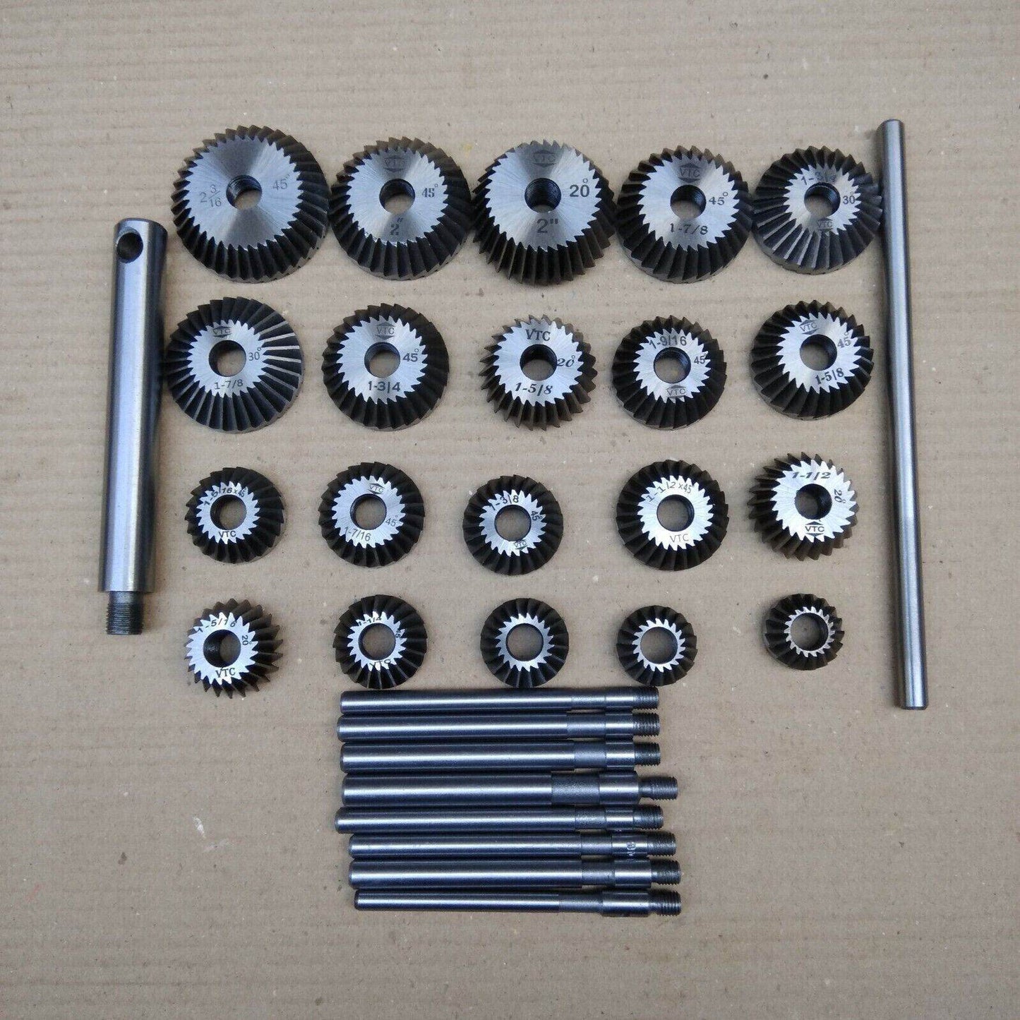 Comprehensive valve seat cutter set with various sizes of cutting tools and attachments for precision machining