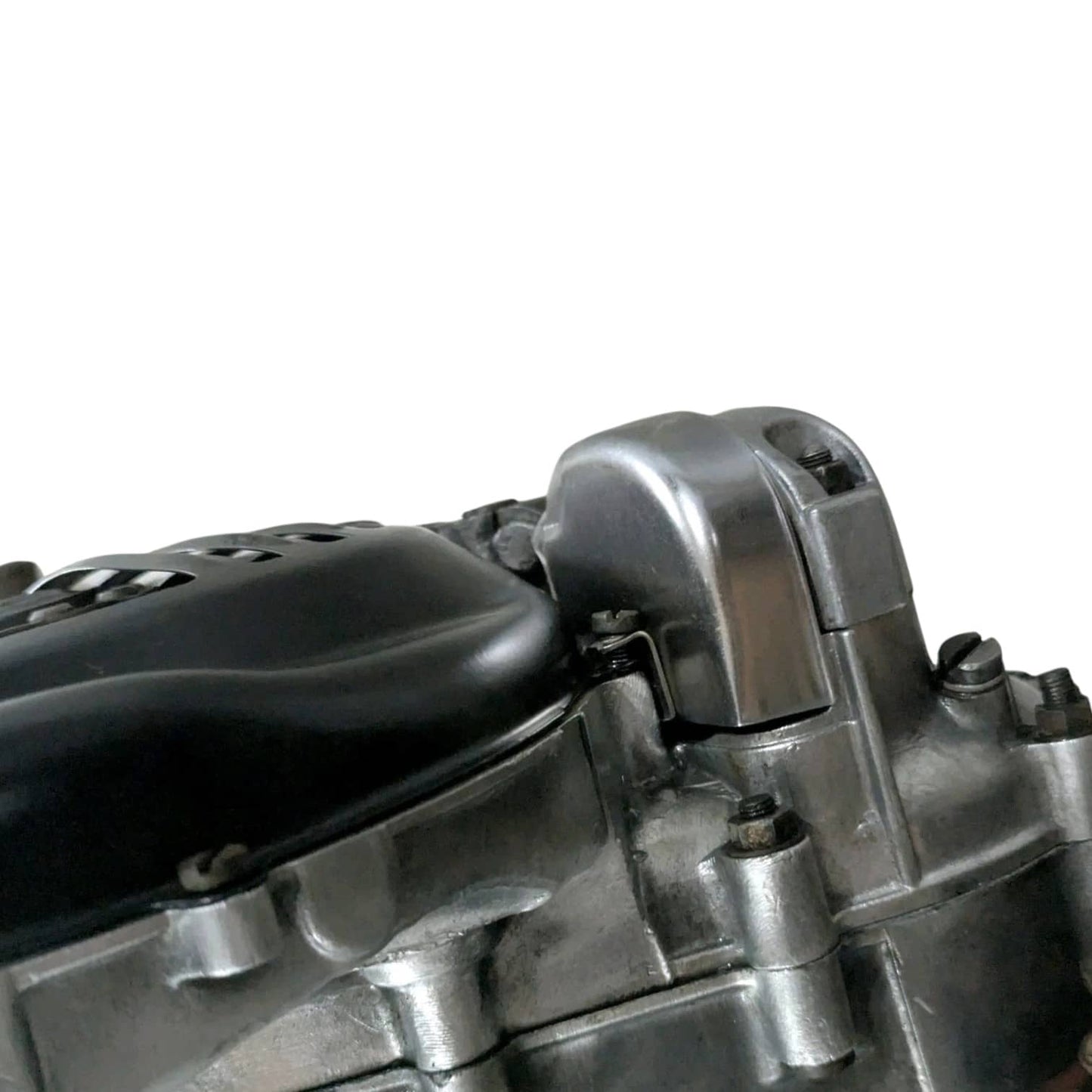 Engine assembly close-up of silver cylinder head and black cover