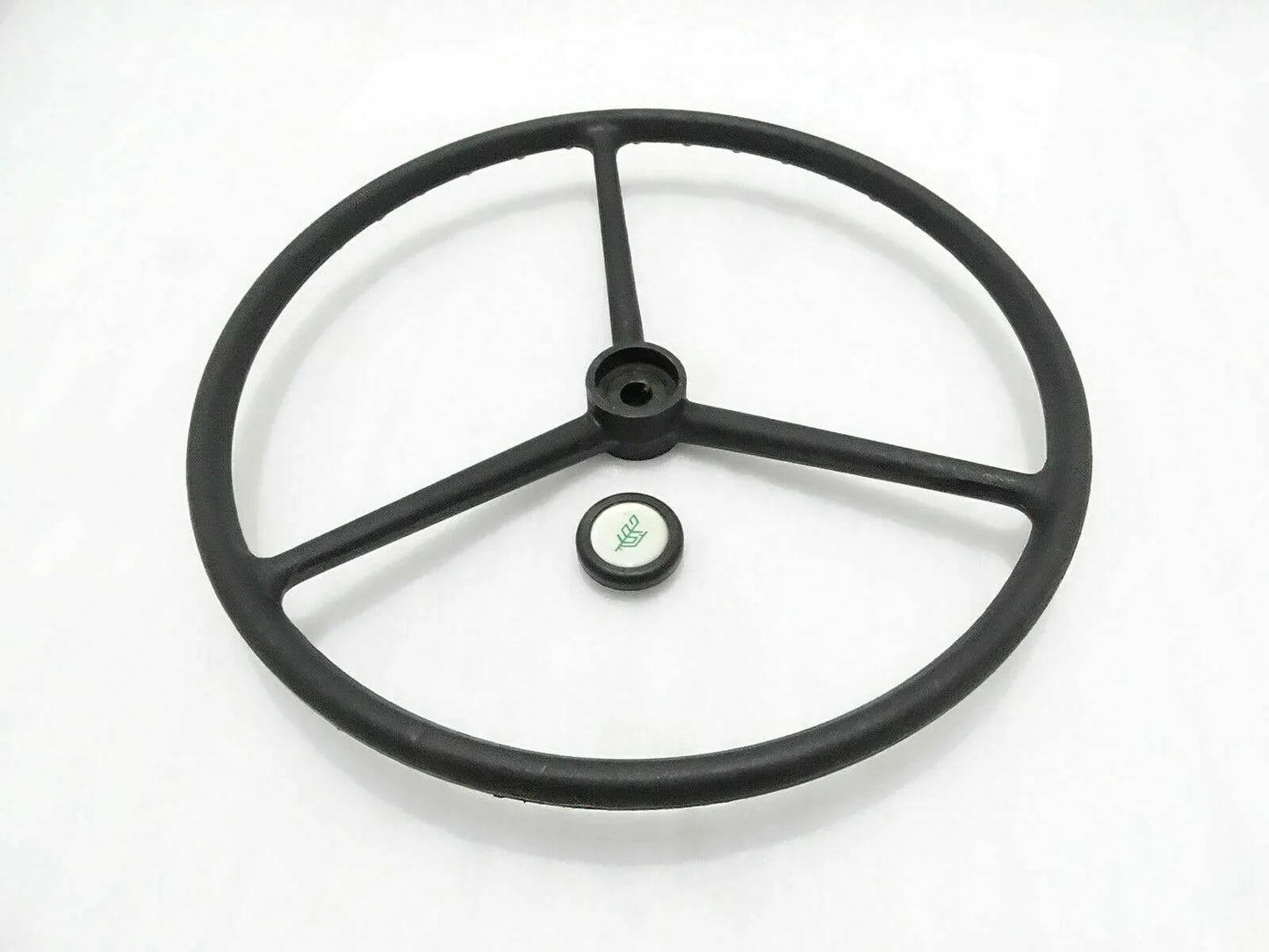 Black tractor wheel steering, durable steel construction, designed for optimal control and maneuverability