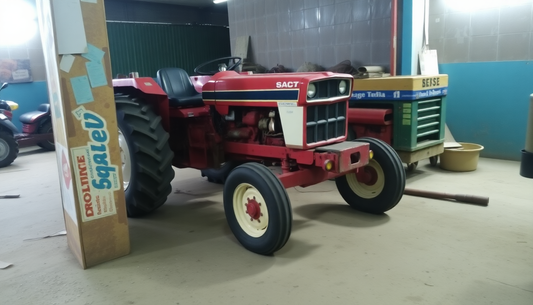 Seasonal tractor checklist featuring a red tractor in a workshop setting with various tools