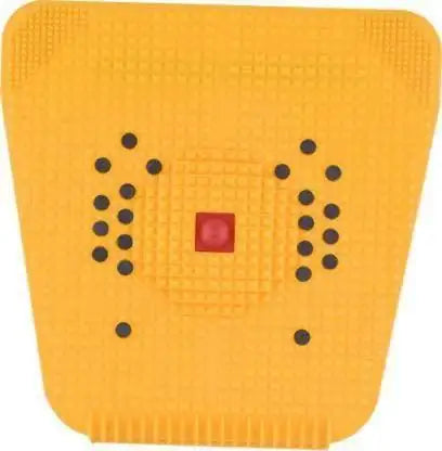 Yellow acupressure mat with raised nubs and dot grid patterns