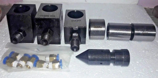 Diesel injector adapter kit with metal sleeves, cylindrical tool, and small fittings