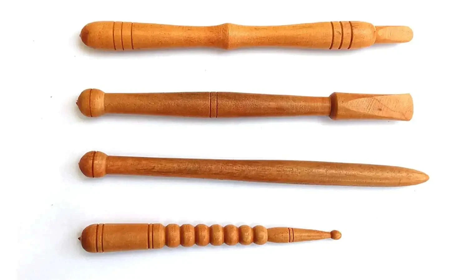 Set of four brown wooden acupressure sticks with ergonomic grip.