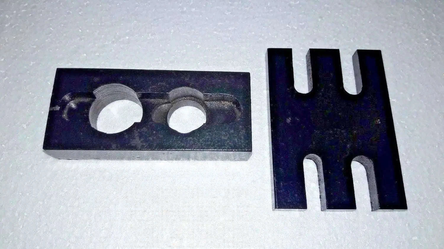 Metal injector adapter plate with two circular holes and forked holder prongs