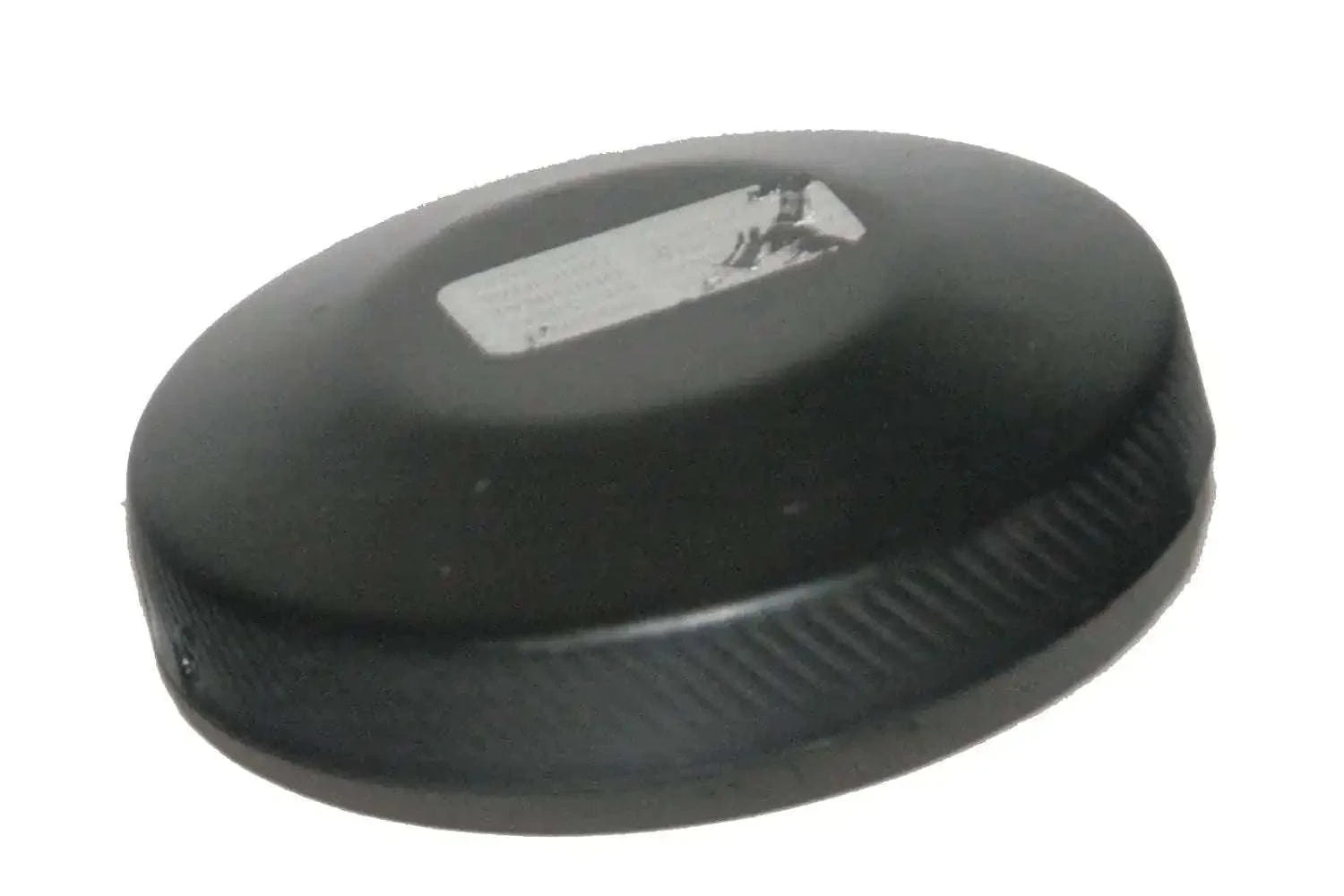 Black tractor fuel cap, round rubber top with ridged grip edge and label