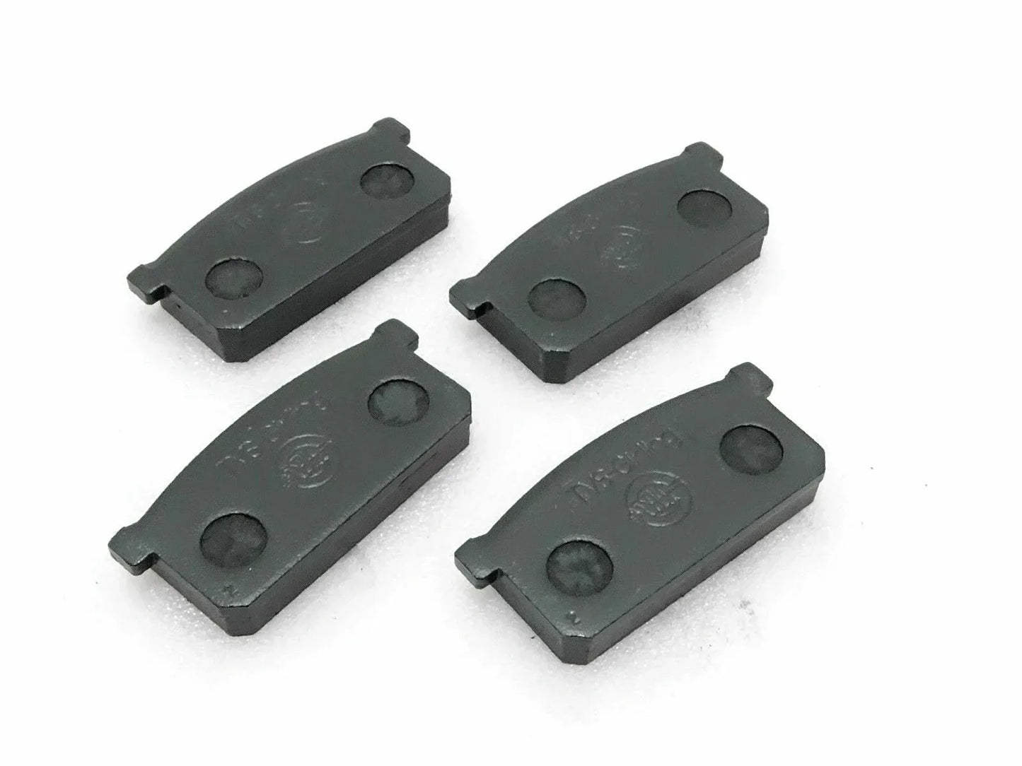 Front brake pad set of four, dark gray metal pads with mounting tabs