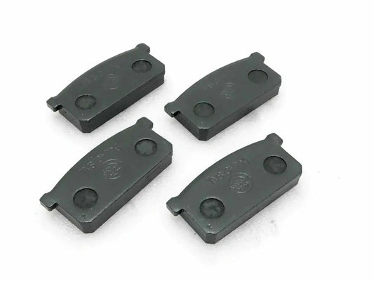 Front brake pad set of four, dark gray metal pads with mounting tabs