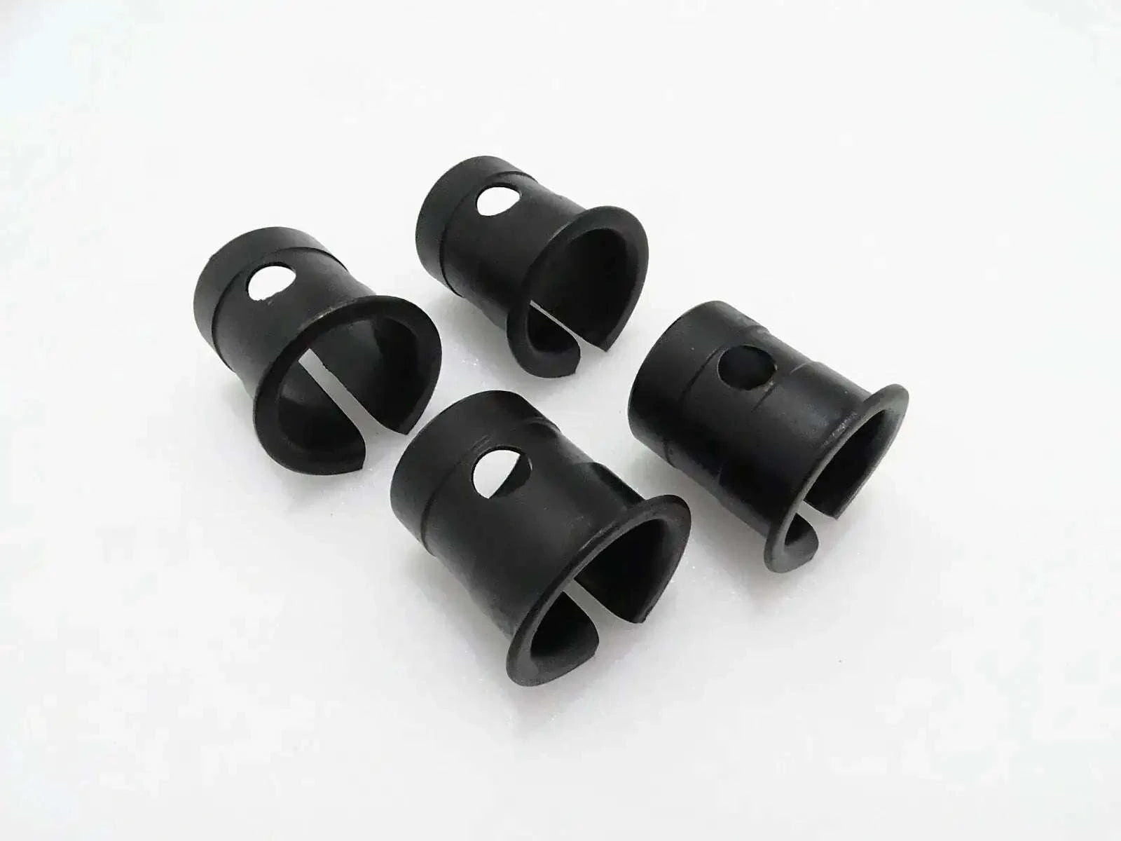 Set of four black cylindrical bushings for machine linkage