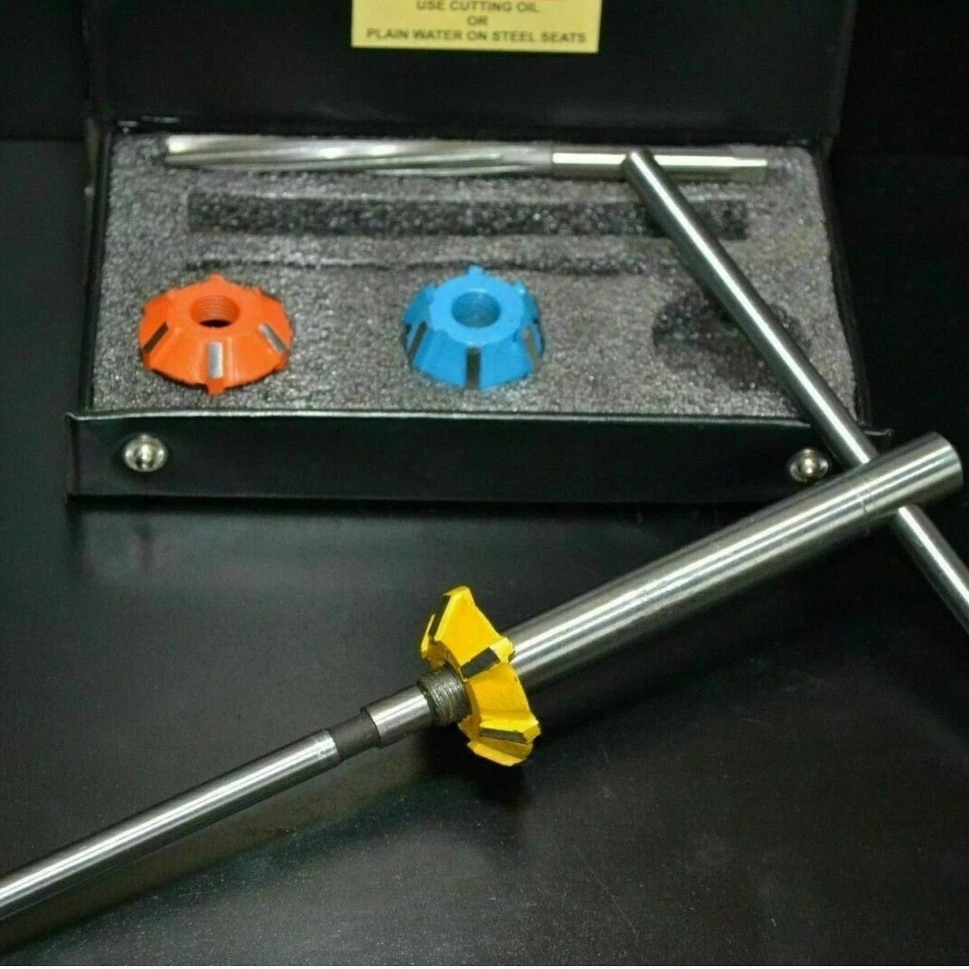 Valve seat cutter set with yellow cutter head and two long guide bars in case
