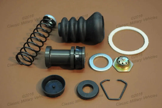 Master cylinder repair kit with black rubber boot, springs, gaskets, and metal parts.