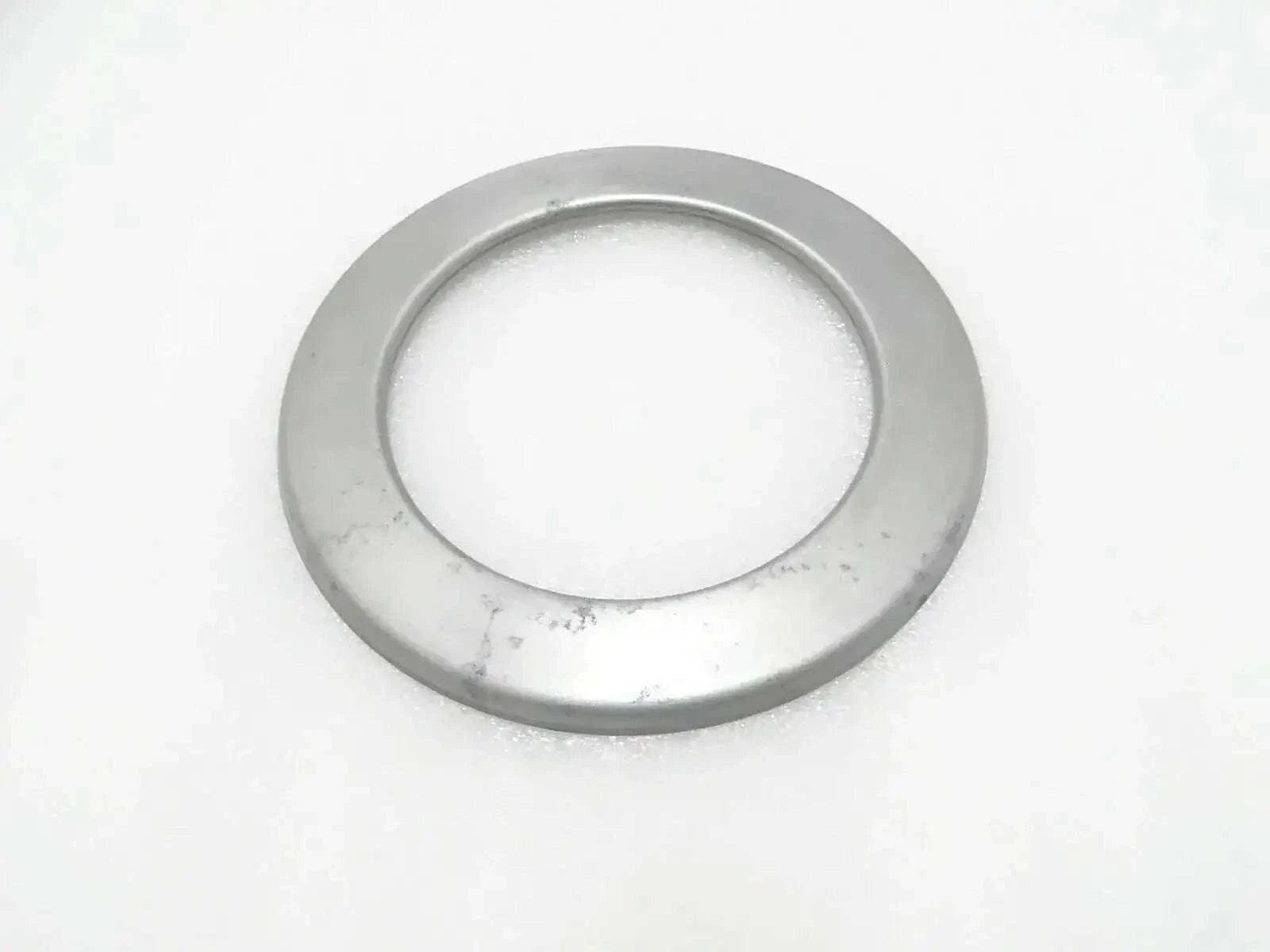 Circular metal hub seal cover with central opening, round flange