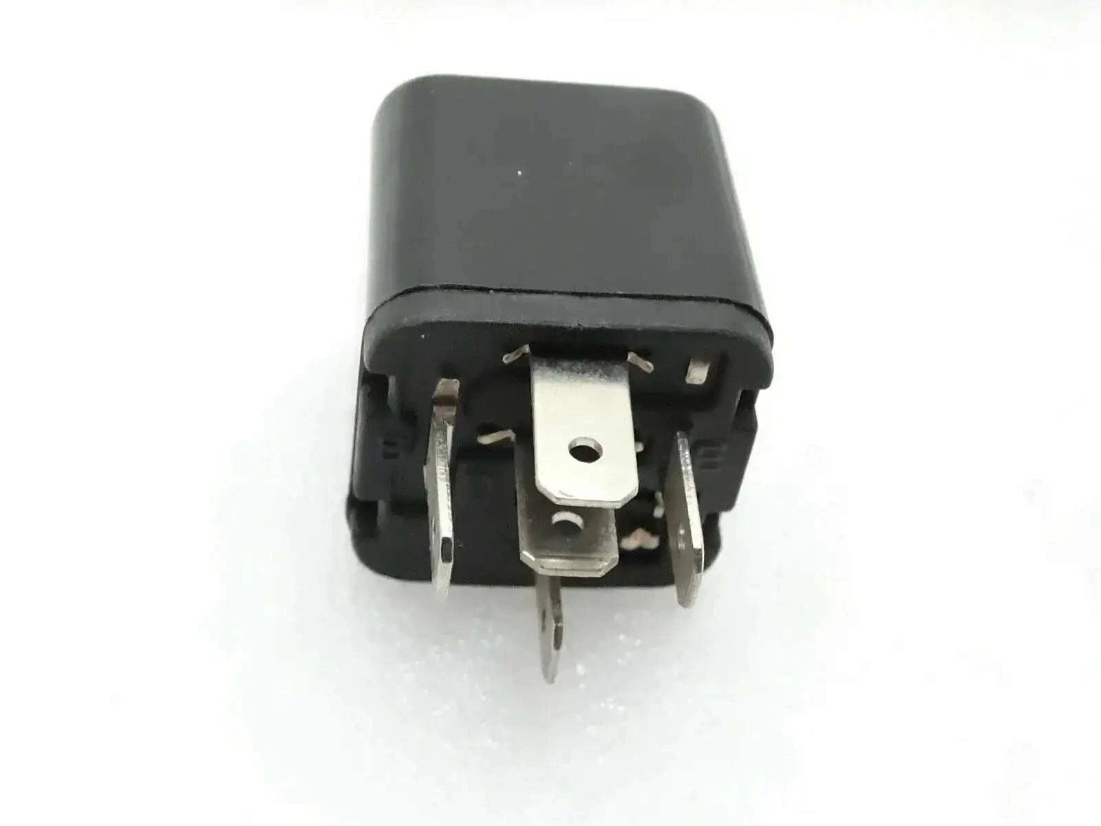 Black automotive relay switch with visible metal terminals