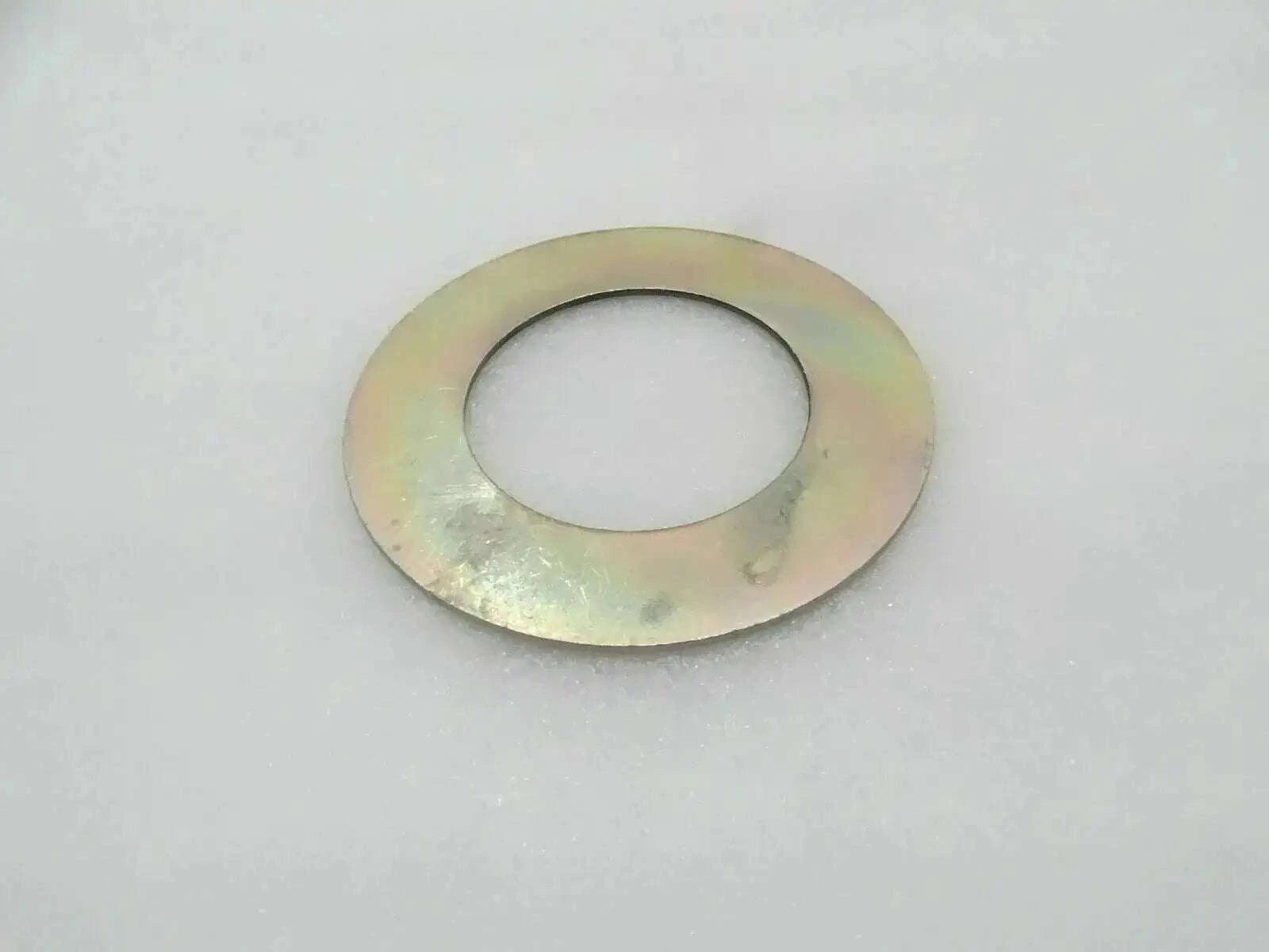 Metal circular shim washer with central hole, yellow-gold finish.