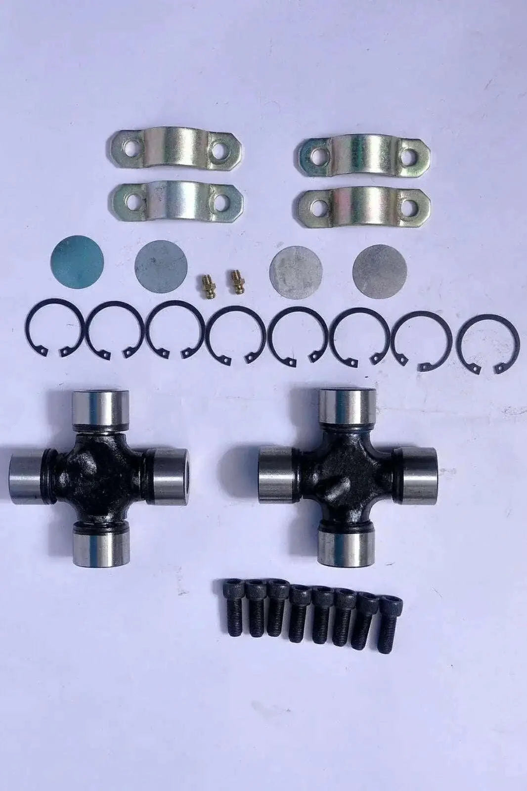 Universal joint kit with two cross assemblies, metal yokes, circlips, bolts and washers