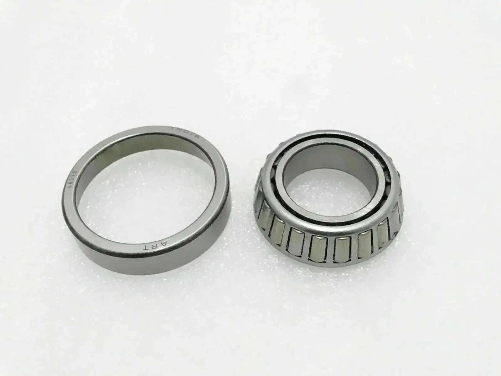 Tapered roller bearing set with inner and outer rings, silver and dark steel