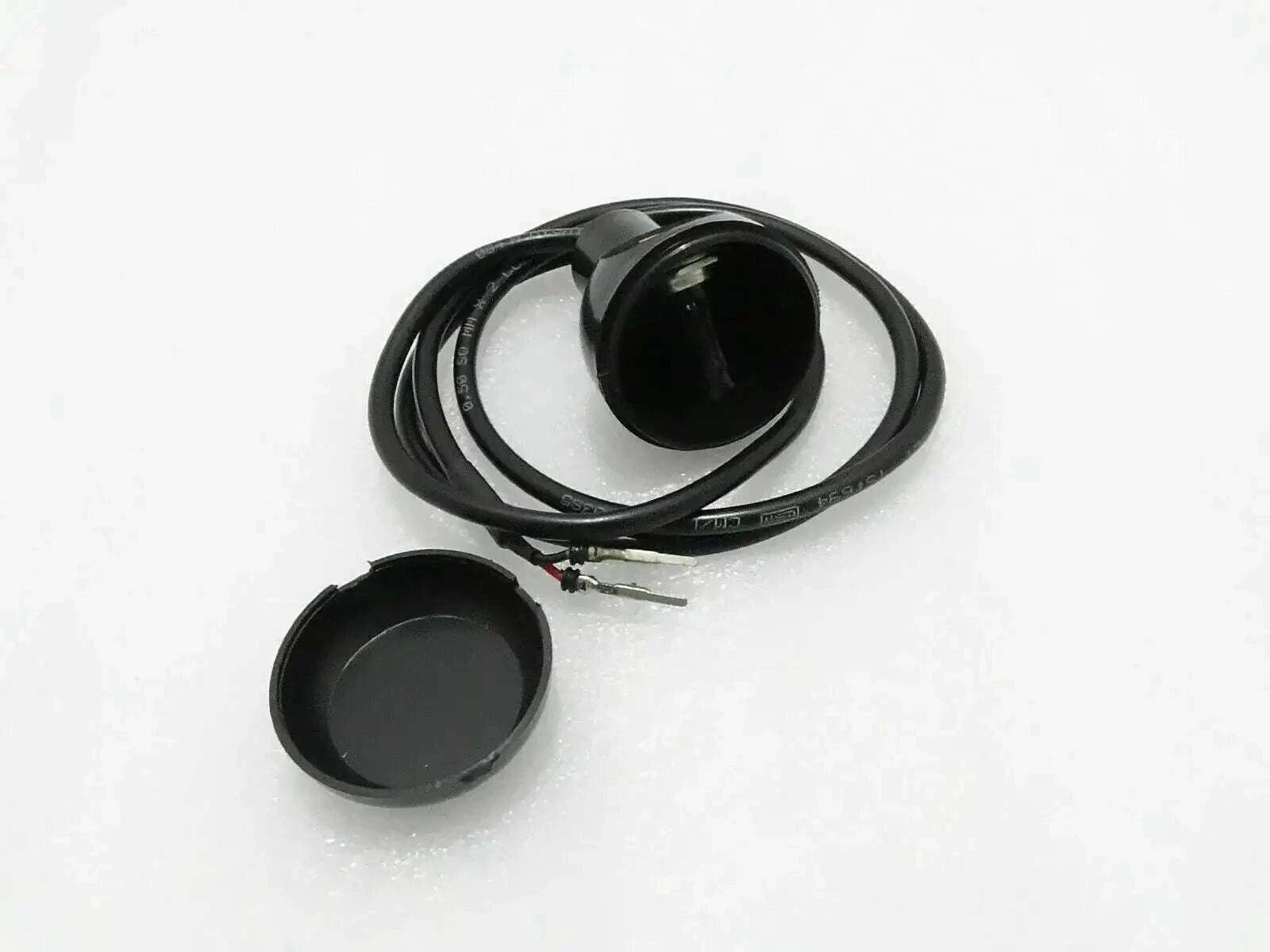 Micro switch with black round actuator cap and attached wire harness
