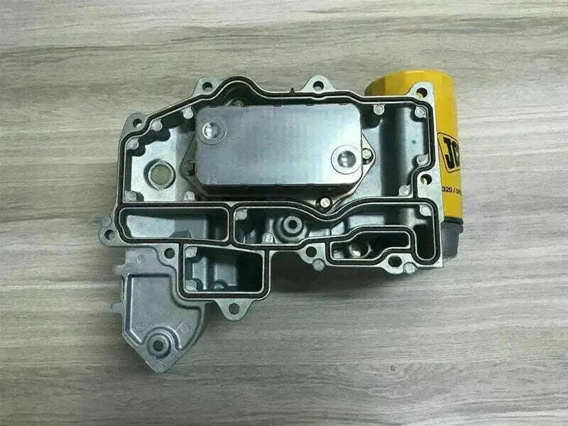 Oil cooler assembly with metal housing and mounting bolt holes