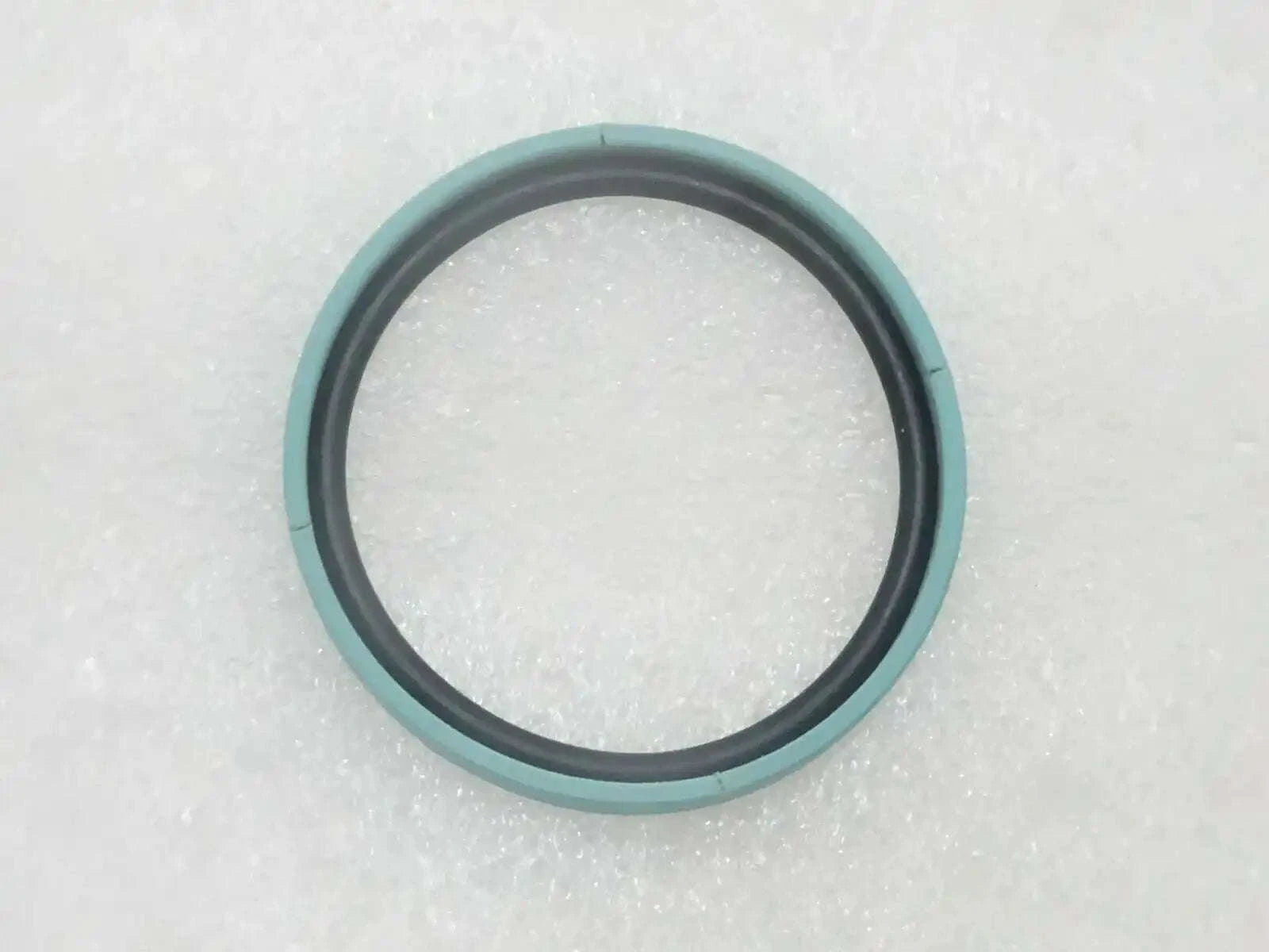 Teal and black piston seal ring, round with inner sealing edge